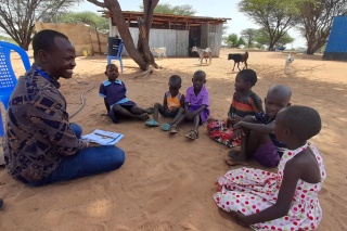 children sitting listening attentively 