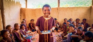 a boy holds a plate of food