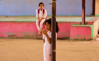 a girl eats outside her school